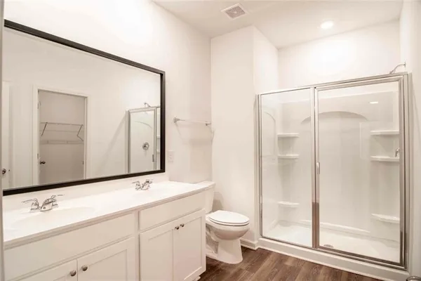 a bathroom with a toilet a sink and a mirror
