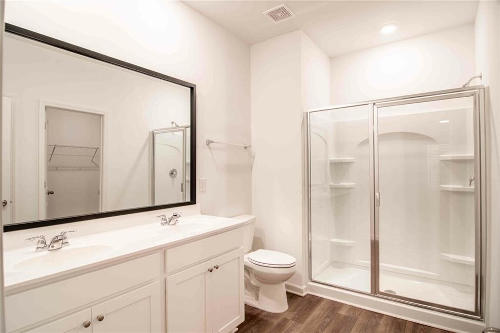 12006 Crosswicks Road, Unit SUNBURST Union City, GA 30291 - Photo 23 of 24 a bathroom with a toilet a sink and a mirror