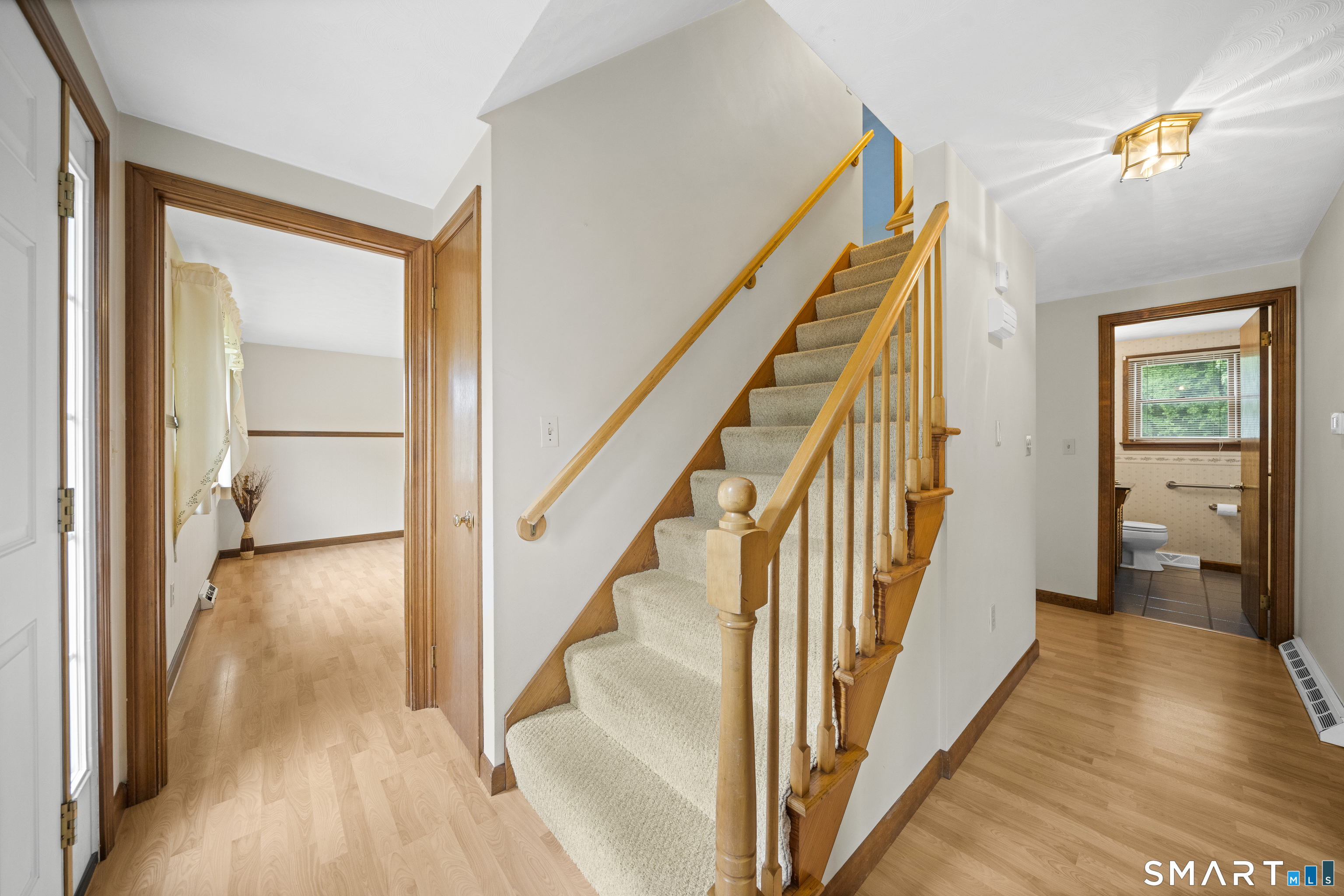 6 Cartier Road Enfield, CT 06082 - Photo 21 of 40 a view of a hallway with wooden floor and staircase