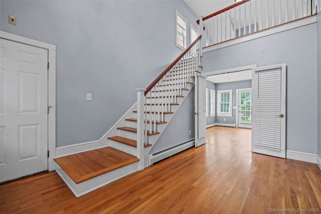88 Powder Hill Road Middlefield, CT 06455 - Photo 12 of 40 a view of an empty room with wooden floor and stairs