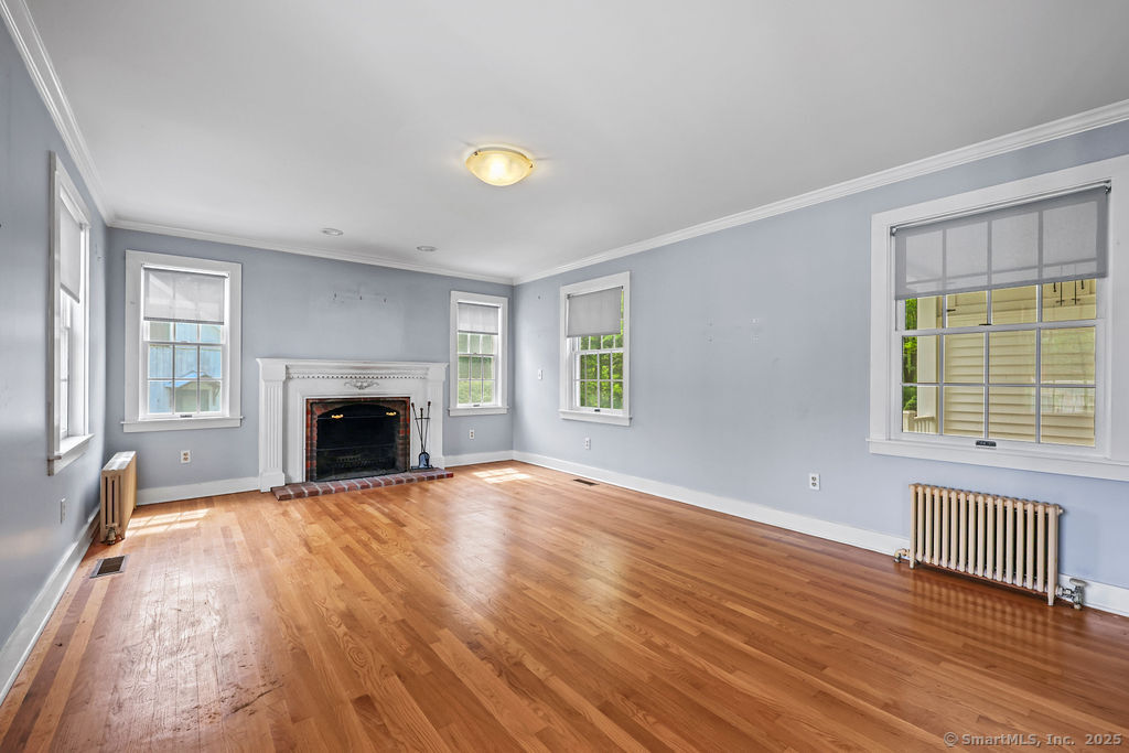 88 Powder Hill Road Middlefield, CT 06455 - Photo 13 of 40 a view of empty room with wooden floor and fireplace