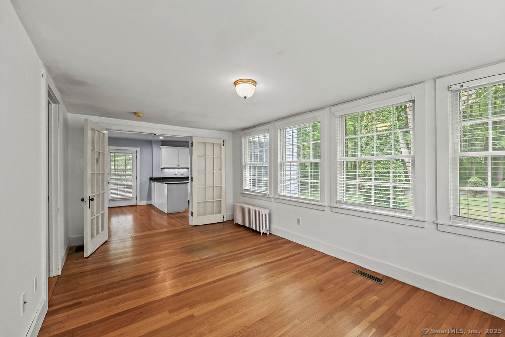 88 Powder Hill Road Middlefield, CT 06455 - Photo 15 of 40 a view of an empty room with a window and wooden floor