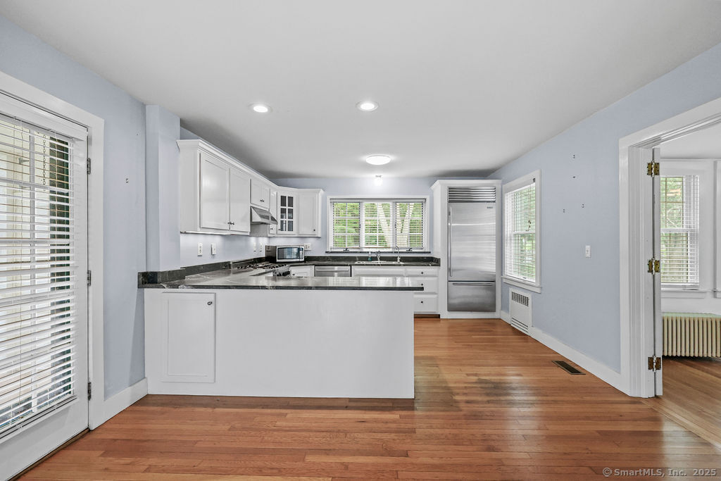 88 Powder Hill Road Middlefield, CT 06455 - Photo 17 of 40 a kitchen with stainless steel appliances granite countertop a stove and a refrigerator