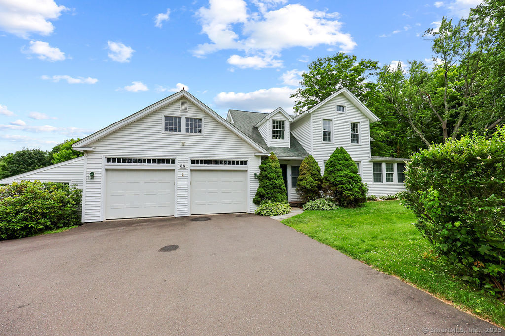 88 Powder Hill Road Middlefield, CT 06455 - Photo 2 of 40 a front view of a house with a yard and garage