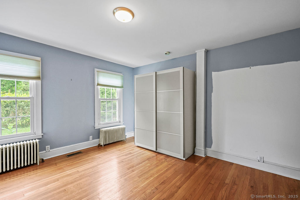 88 Powder Hill Road Middlefield, CT 06455 - Photo 21 of 40 an empty room with wooden floor and windows