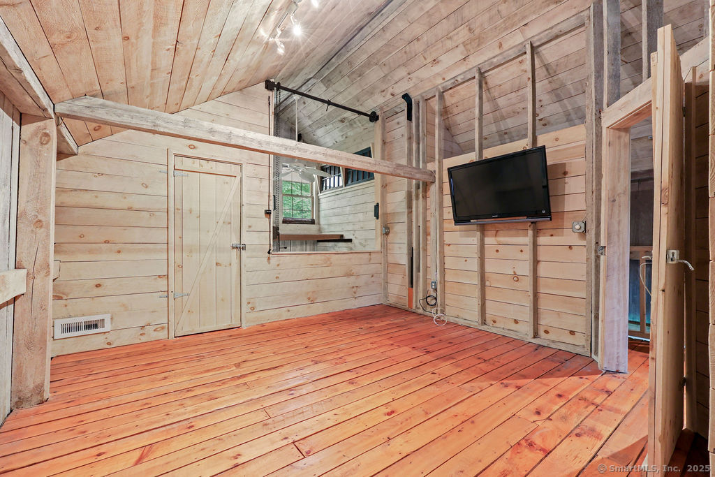 88 Powder Hill Road Middlefield, CT 06455 - Photo 34 of 40 a bedroom with a bed and a flat screen tv