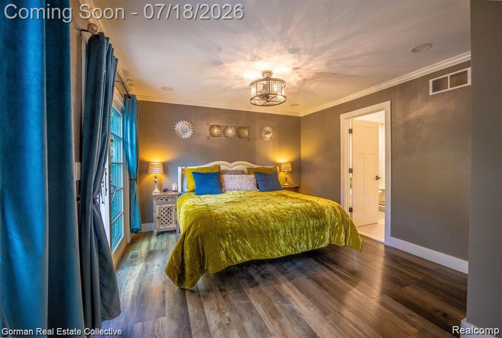 283 Phillips Avenue Clawson, MI 48017 - Photo 11 of 26 Primary bedroom. New luxury vinyl flooring throughout, sliding glass door to double lot private backyard, ensuite bathroom and walk in closet