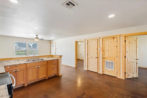 a spacious bathroom with a granite countertop sink and a bathtub