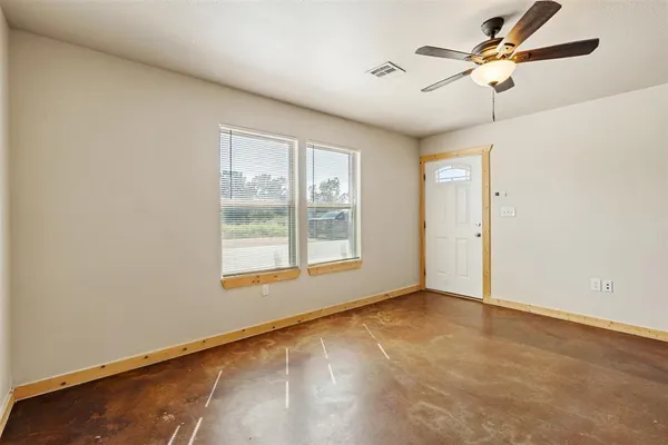 a view of an empty room with a window
