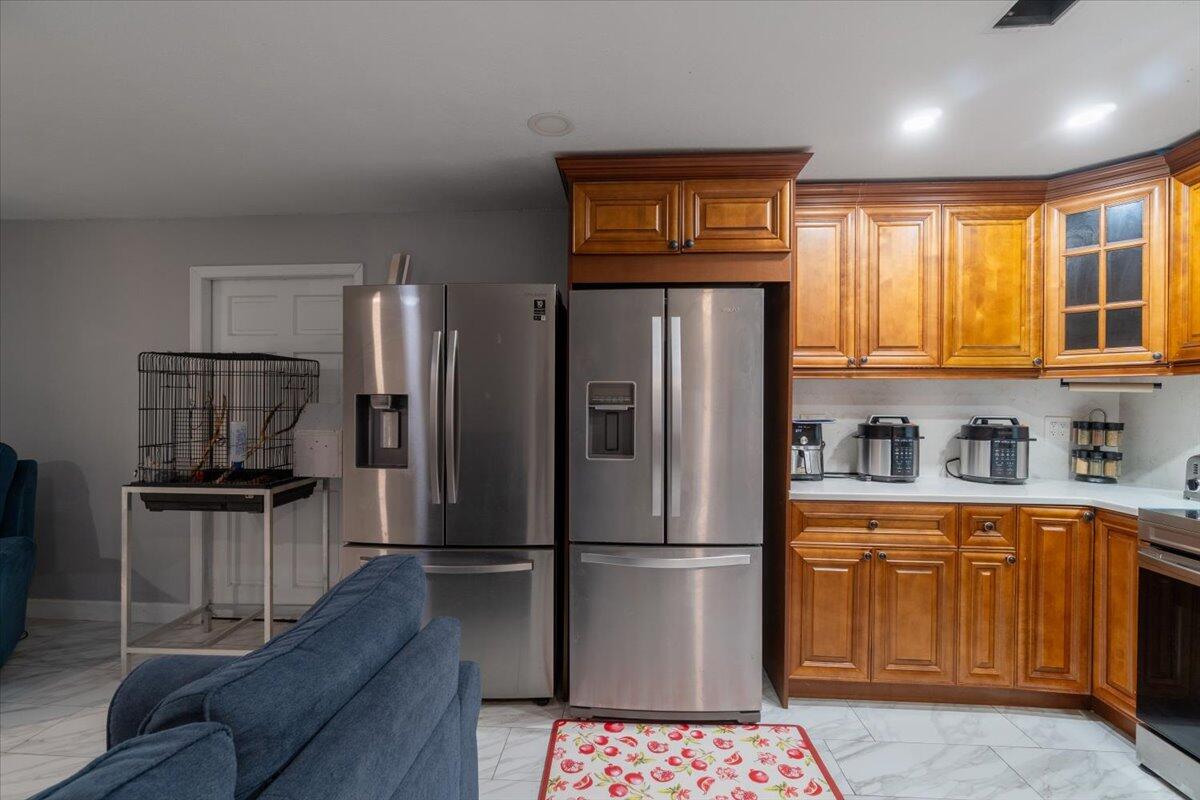 430 80th Street Marathon, FL 33050 - Photo 11 of 44 a kitchen with stainless steel appliances a refrigerator and a stove top oven