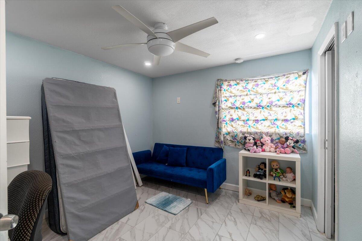 430 80th Street Marathon, FL 33050 - Photo 14 of 44 a living room with furniture a chandelier and a window