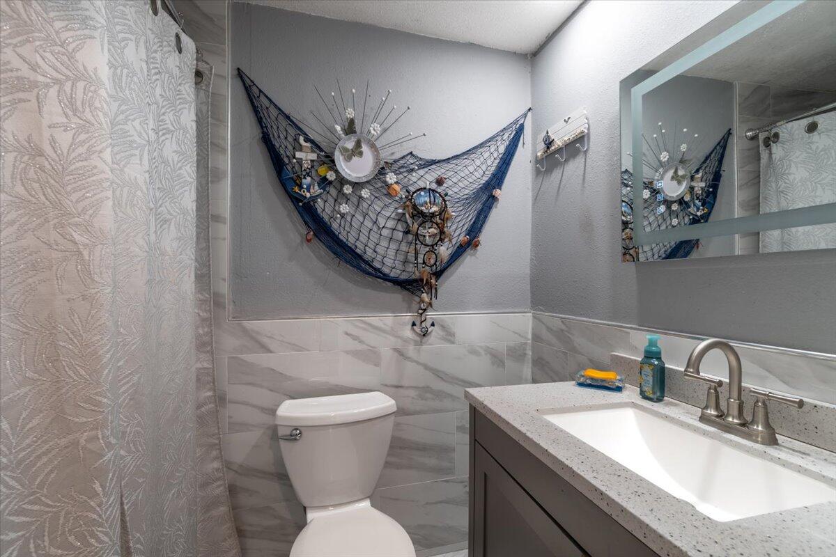 430 80th Street Marathon, FL 33050 - Photo 16 of 44 a bathroom with a toilet sink and mirror