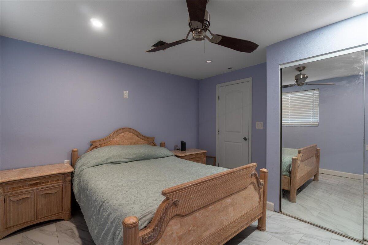 430 80th Street Marathon, FL 33050 - Photo 19 of 44 a bedroom with a bed and a ceiling fan