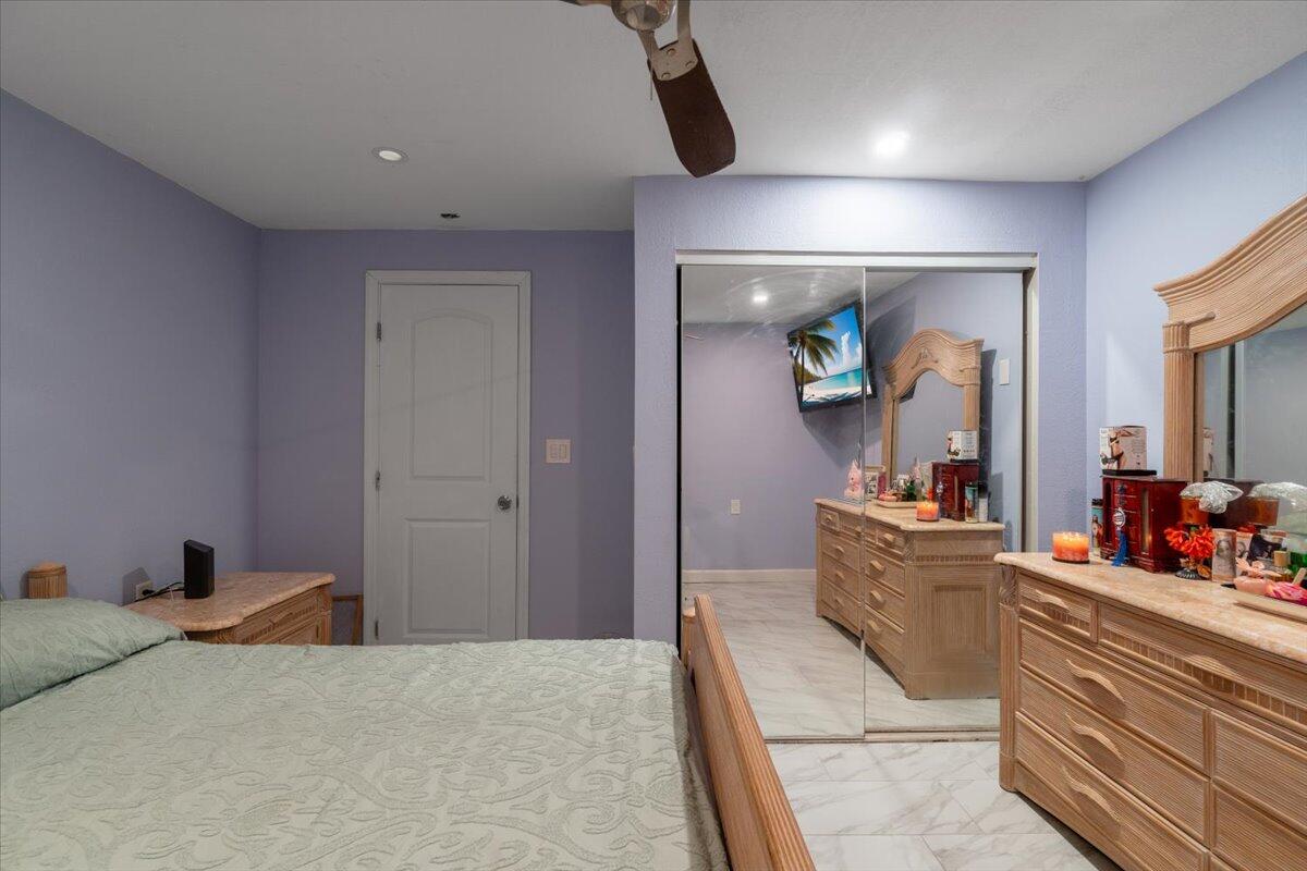 430 80th Street Marathon, FL 33050 - Photo 20 of 44 a bedroom with a bed and a large mirror