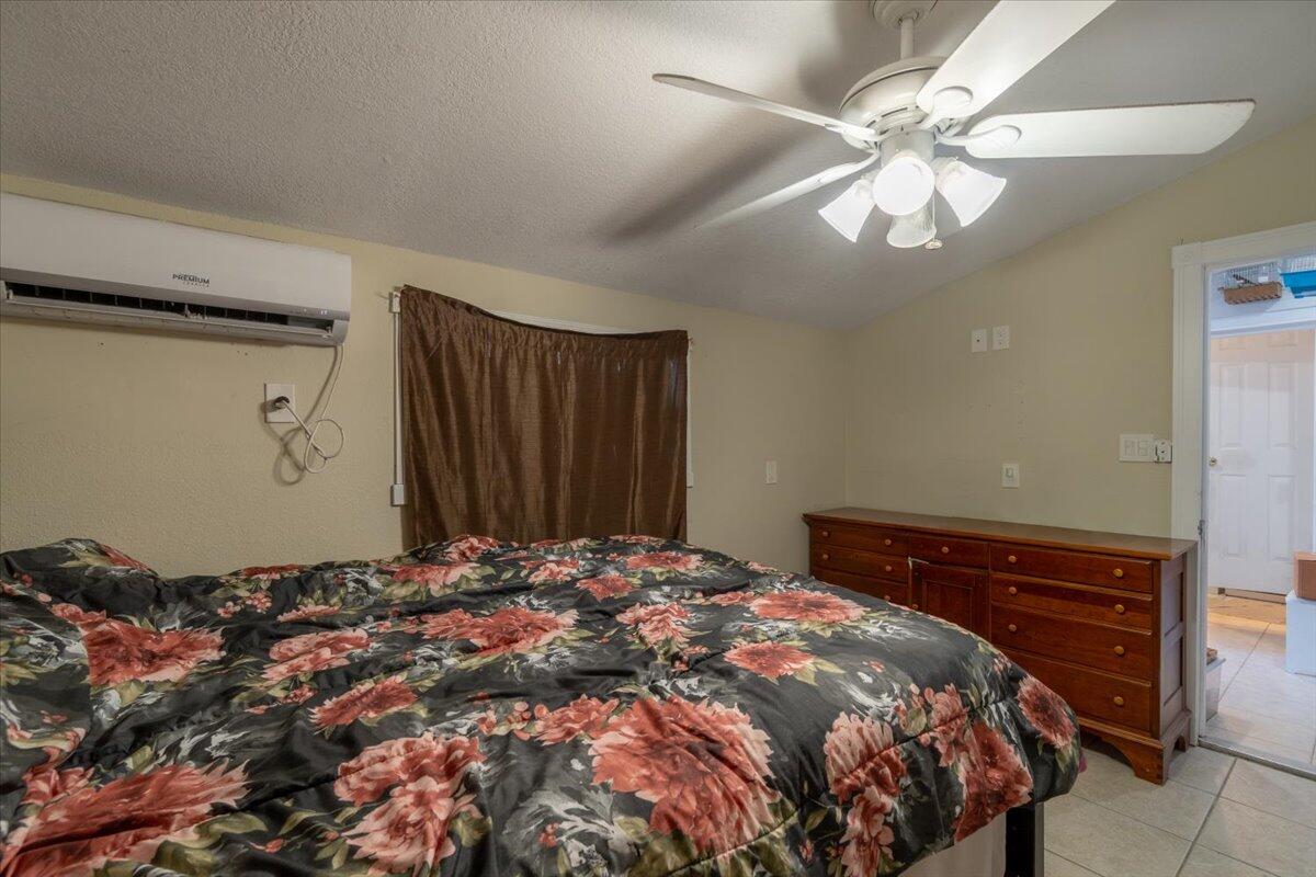 430 80th Street Marathon, FL 33050 - Photo 30 of 44 a bedroom with a bed and a chandelier