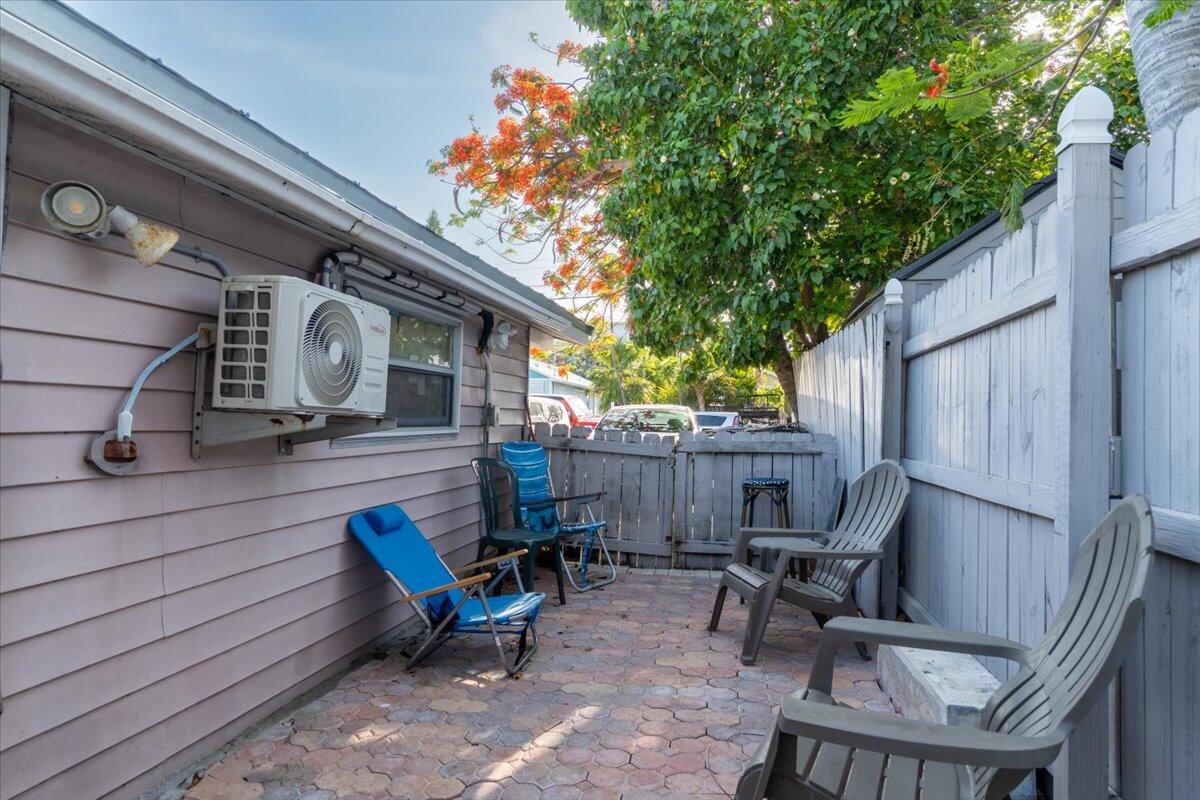 430 80th Street Marathon, FL 33050 - Photo 31 of 44 a view of a patio with table and chairs with wooden fence and plants
