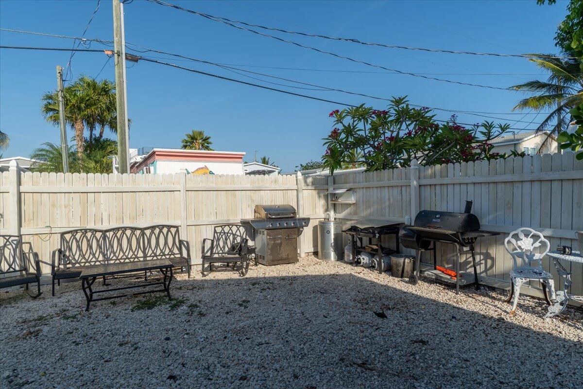 430 80th Street Marathon, FL 33050 - Photo 34 of 44 a view of a chairs and table in the back yard of the house