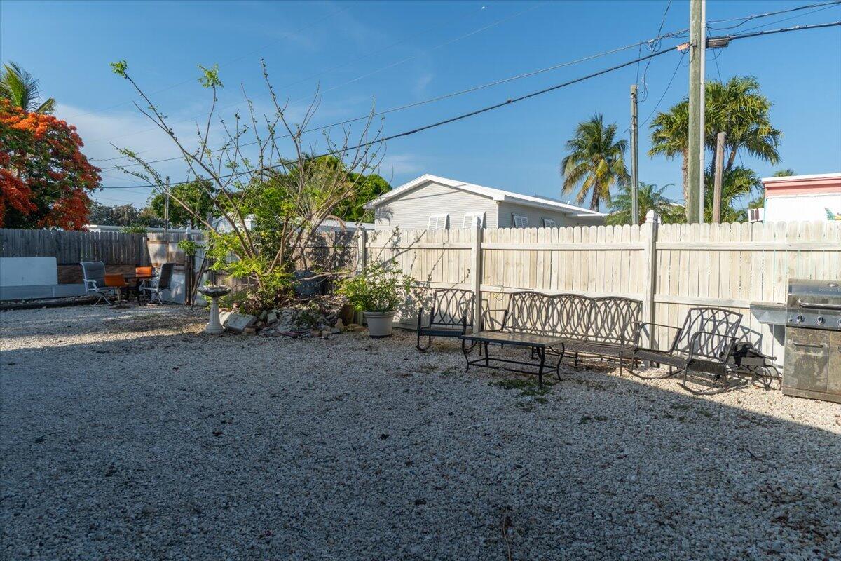 430 80th Street Marathon, FL 33050 - Photo 35 of 44 a view of a house with a yard and potted plants