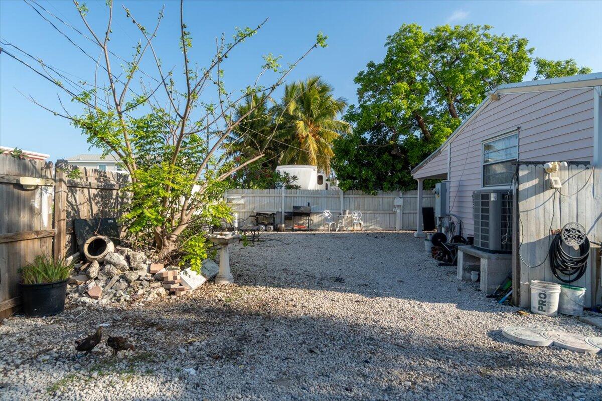 430 80th Street Marathon, FL 33050 - Photo 37 of 44 a backyard of a house with barbeque oven and outdoor seating