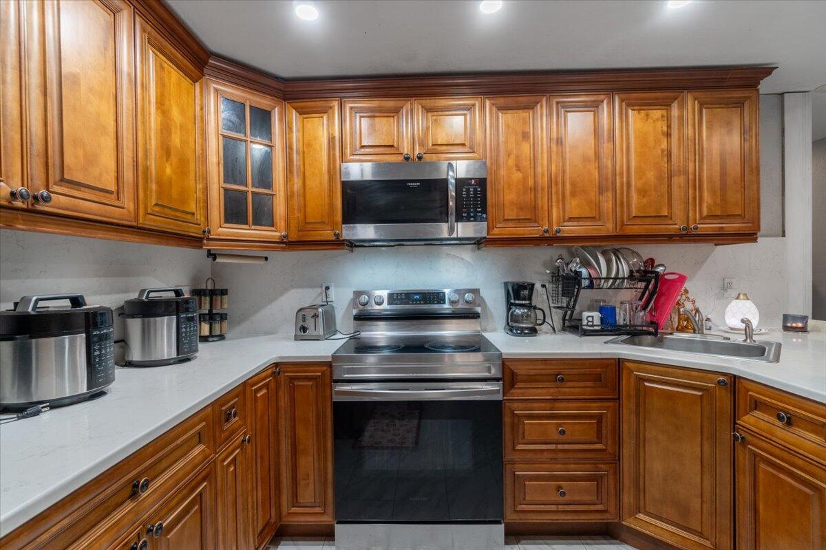 430 80th Street Marathon, FL 33050 - Photo 9 of 44 a kitchen with granite countertop a stove a sink and a microwave