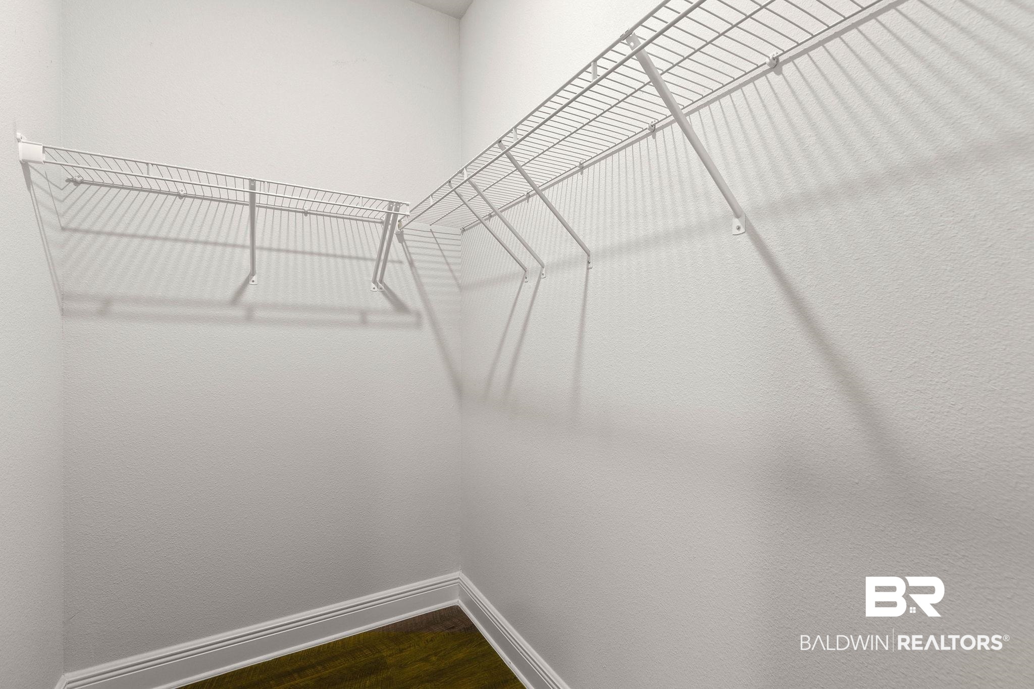 9448 Amethyst Drive Daphne, AL 36526 - Photo 45 of 61 Walk in closet with dark wood-style flooring