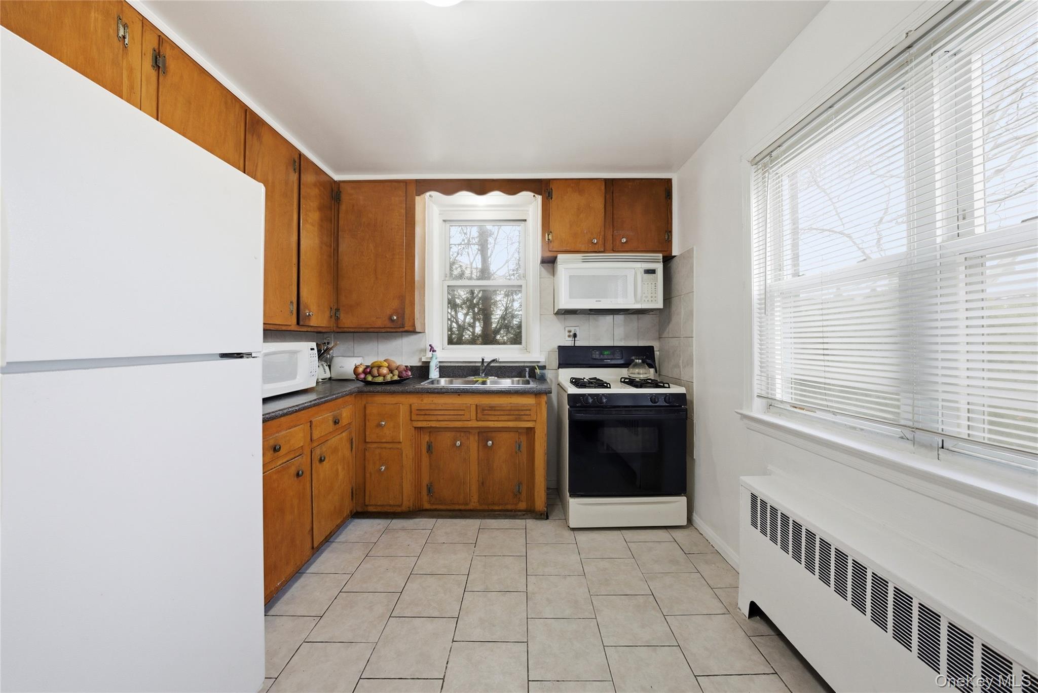 4161 Monticello Avenue Bronx, NY 10466 - Photo 14 of 38 a kitchen with stainless steel appliances granite countertop a stove a sink and a refrigerator