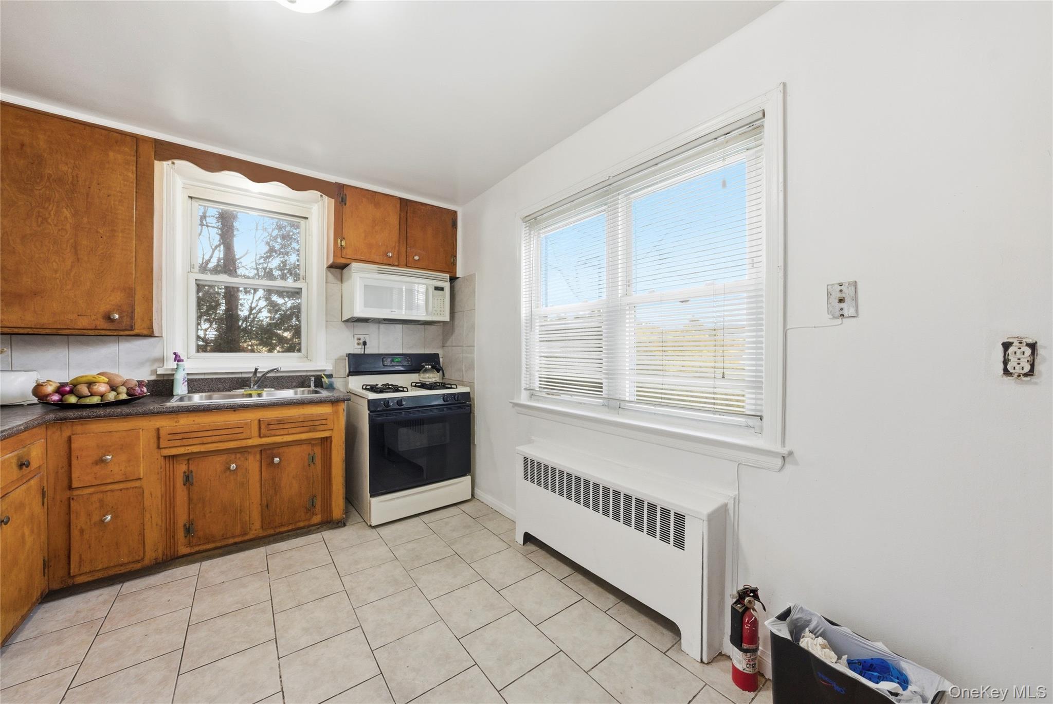 4161 Monticello Avenue Bronx, NY 10466 - Photo 15 of 38 a kitchen with stainless steel appliances granite countertop a stove a sink and a microwave