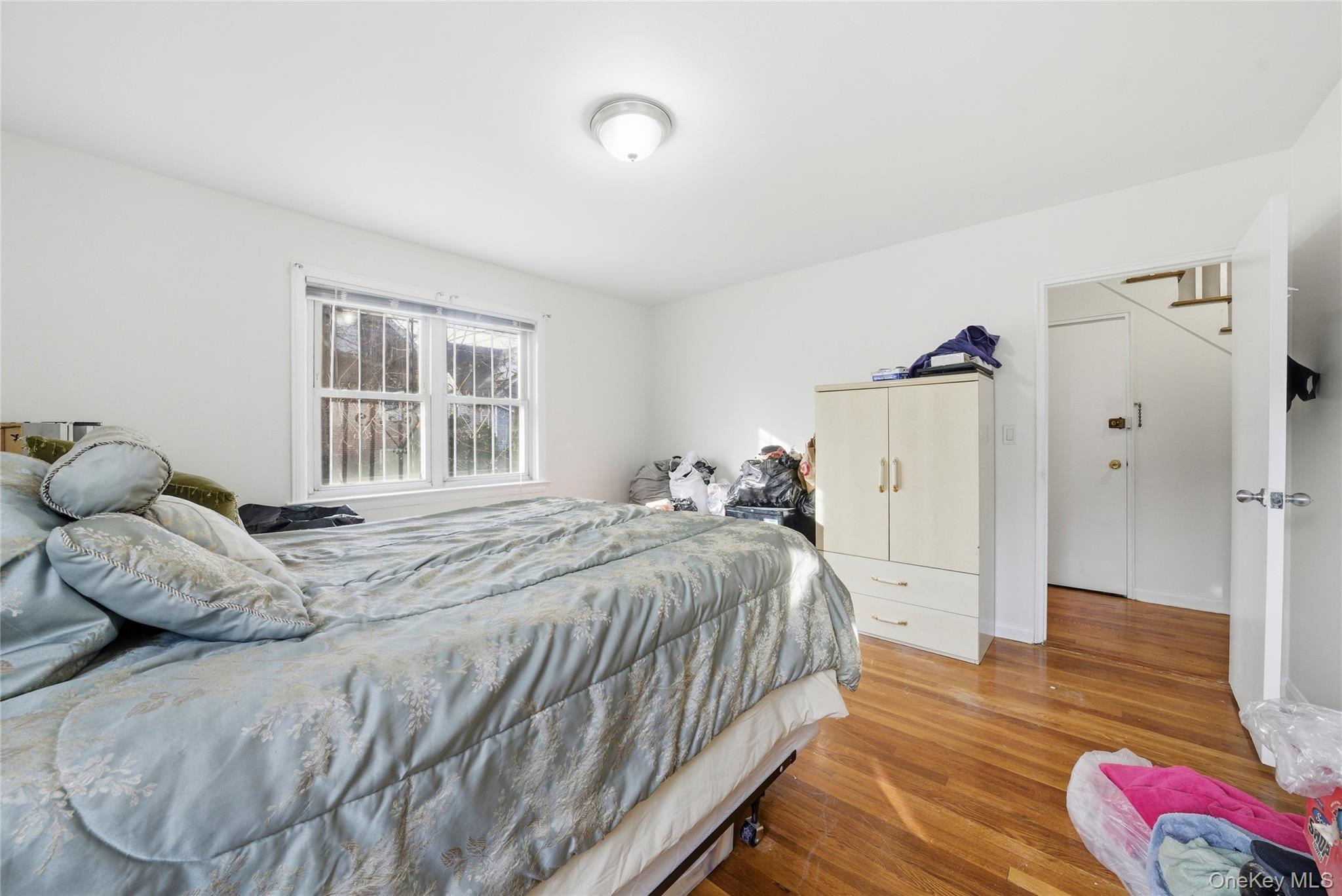 4161 Monticello Avenue Bronx, NY 10466 - Photo 24 of 38 a bedroom with a bed and wooden floor