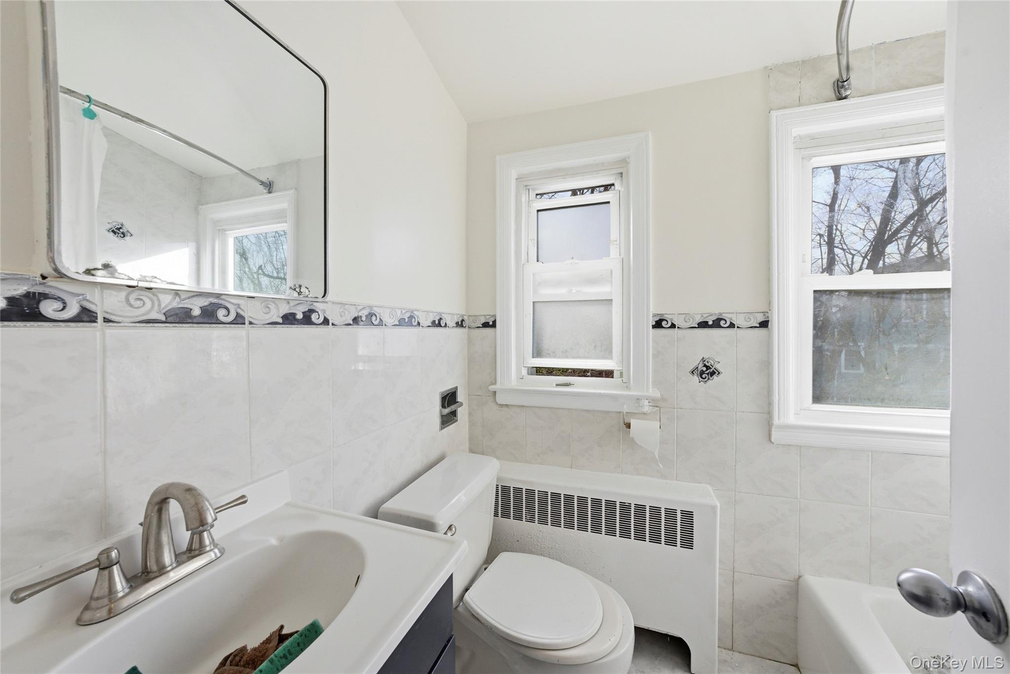 4161 Monticello Avenue Bronx, NY 10466 - Photo 25 of 38 a bathroom with a toilet a sink a window and mirror
