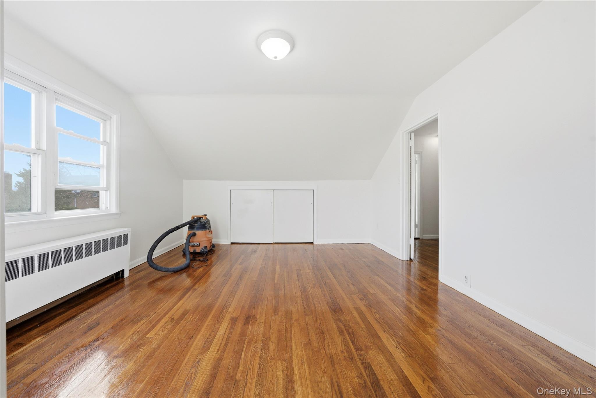 4161 Monticello Avenue Bronx, NY 10466 - Photo 28 of 38 an empty room with wooden floor and windows