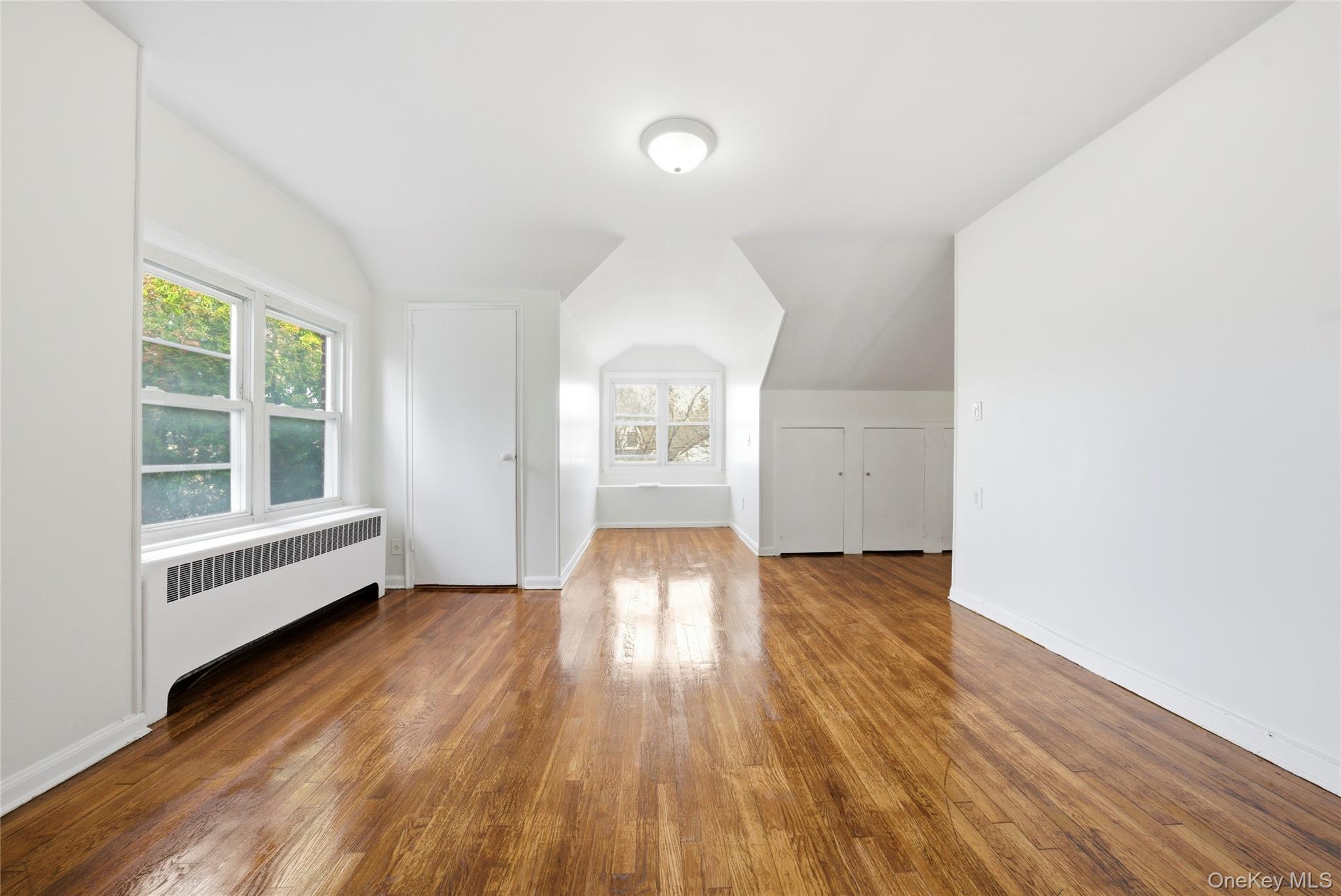 4161 Monticello Avenue Bronx, NY 10466 - Photo 31 of 38 an empty room with wooden floor and windows
