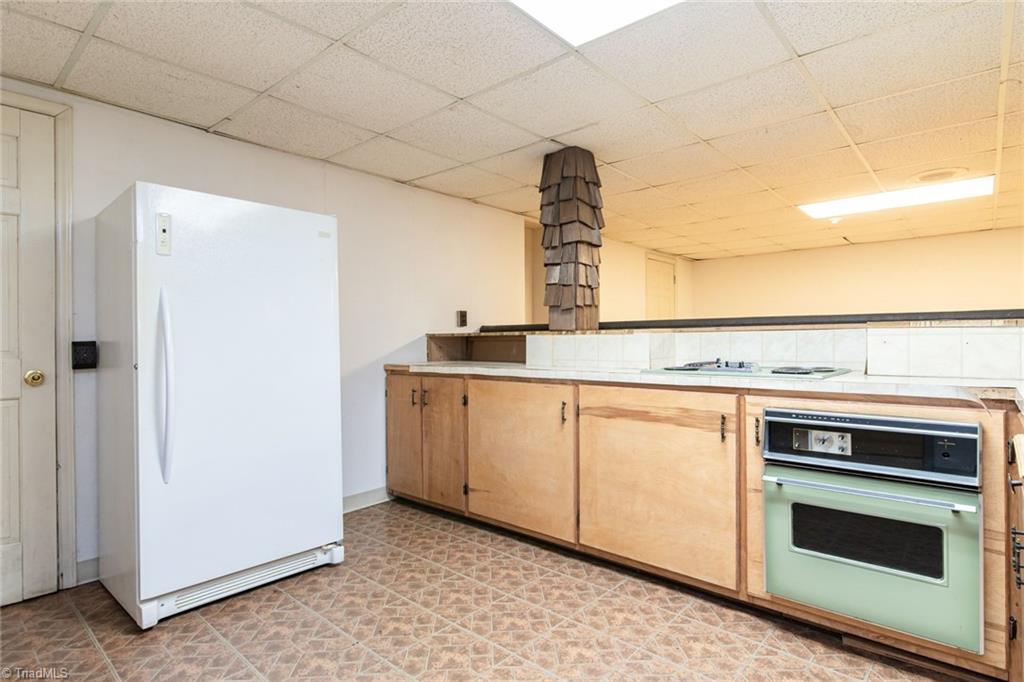 190 Brim Road Mount Airy, NC 27030 - Photo 37 of 49 Basement has a second kitchen with cooktop stove and oven and refrigerator.