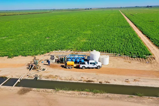 a view of yard with swimming pool and wooden fence