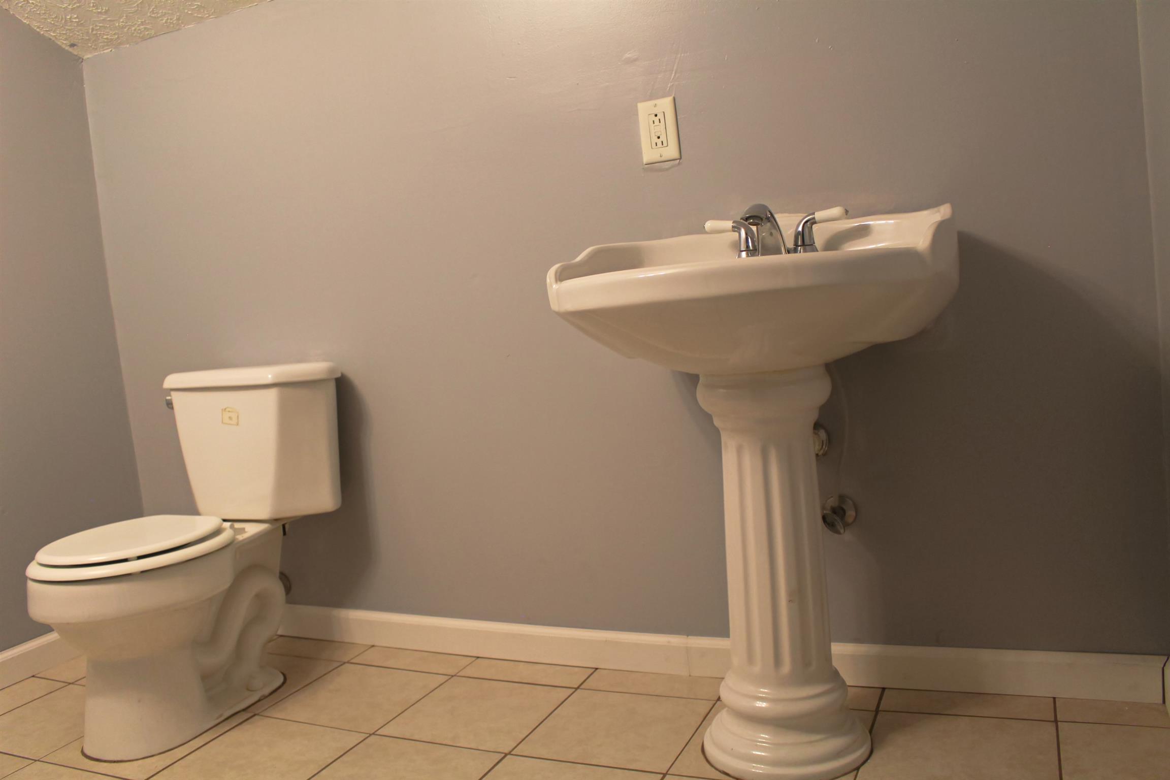2454 Goshen Road Lebanon, TN 37087 - Photo 12 of 18 a bathroom with a sink toilet and a mirror