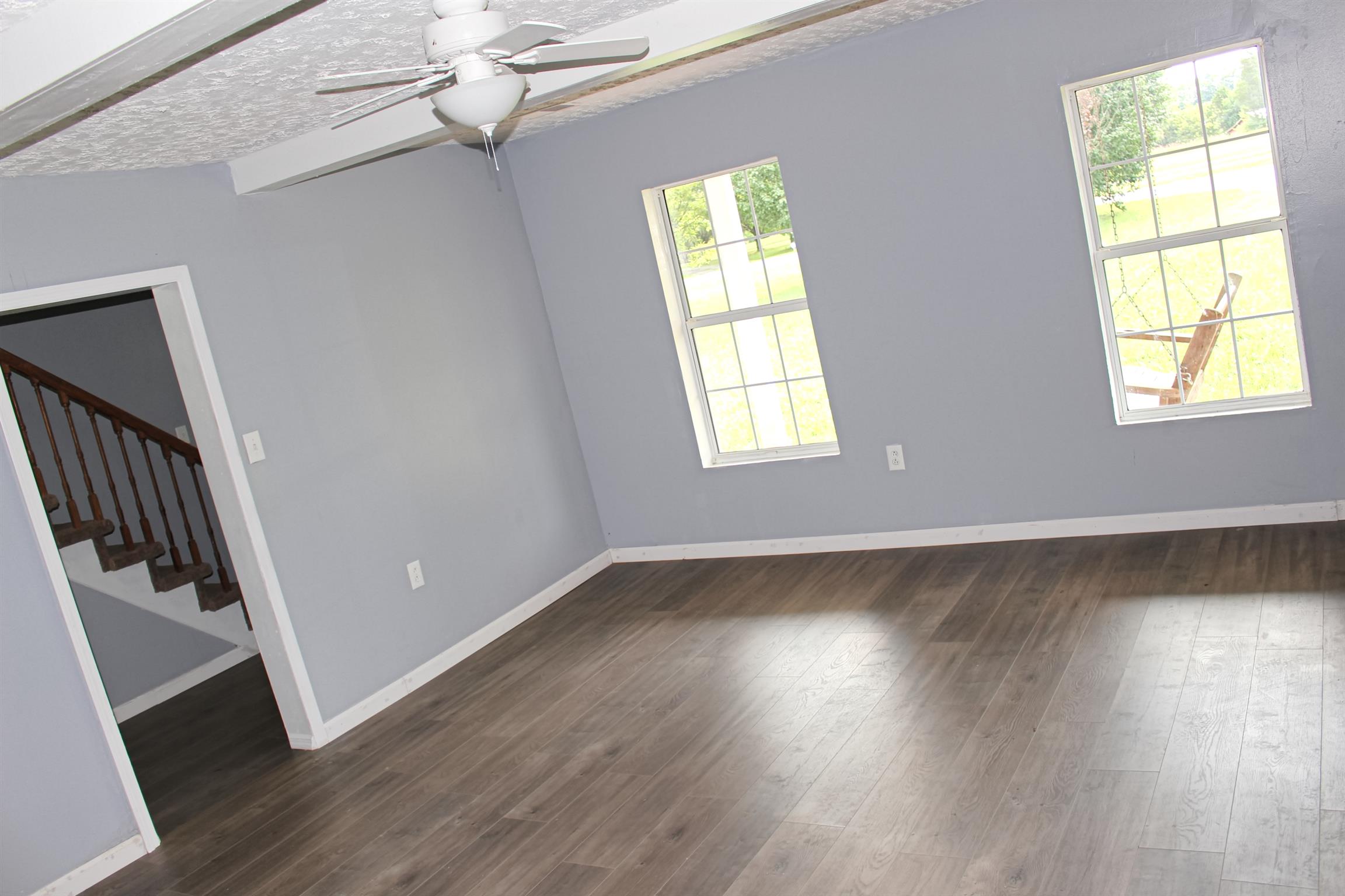 2454 Goshen Road Lebanon, TN 37087 - Photo 4 of 18 a view of an empty room with wooden floor and a window