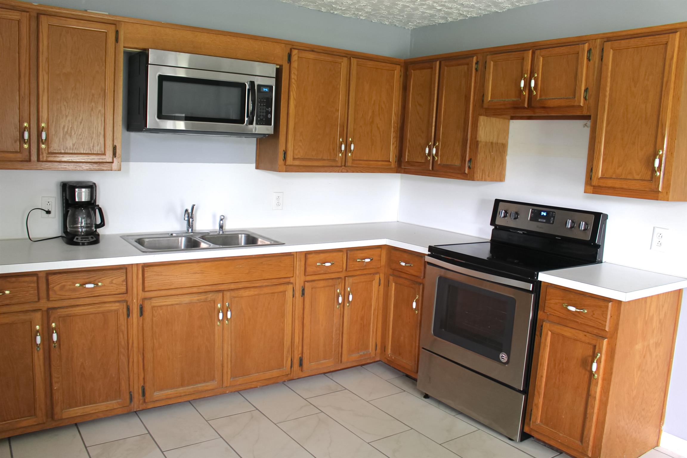 2454 Goshen Road Lebanon, TN 37087 - Photo 5 of 18 a kitchen with stainless steel appliances granite countertop a sink stove and microwave