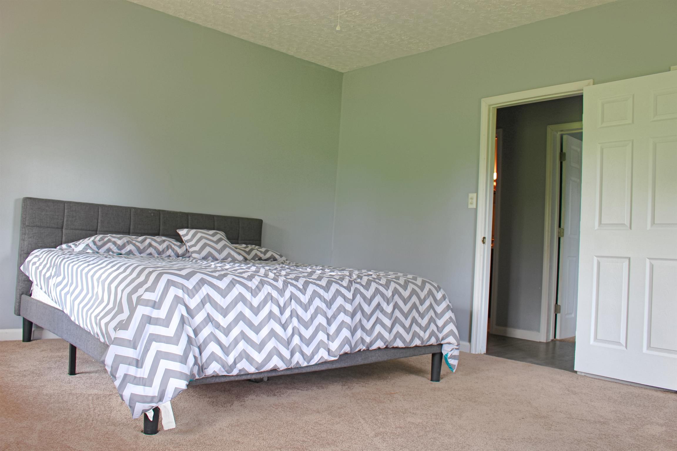 2454 Goshen Road Lebanon, TN 37087 - Photo 10 of 18 a bed sitting in a bedroom next to a bathroom