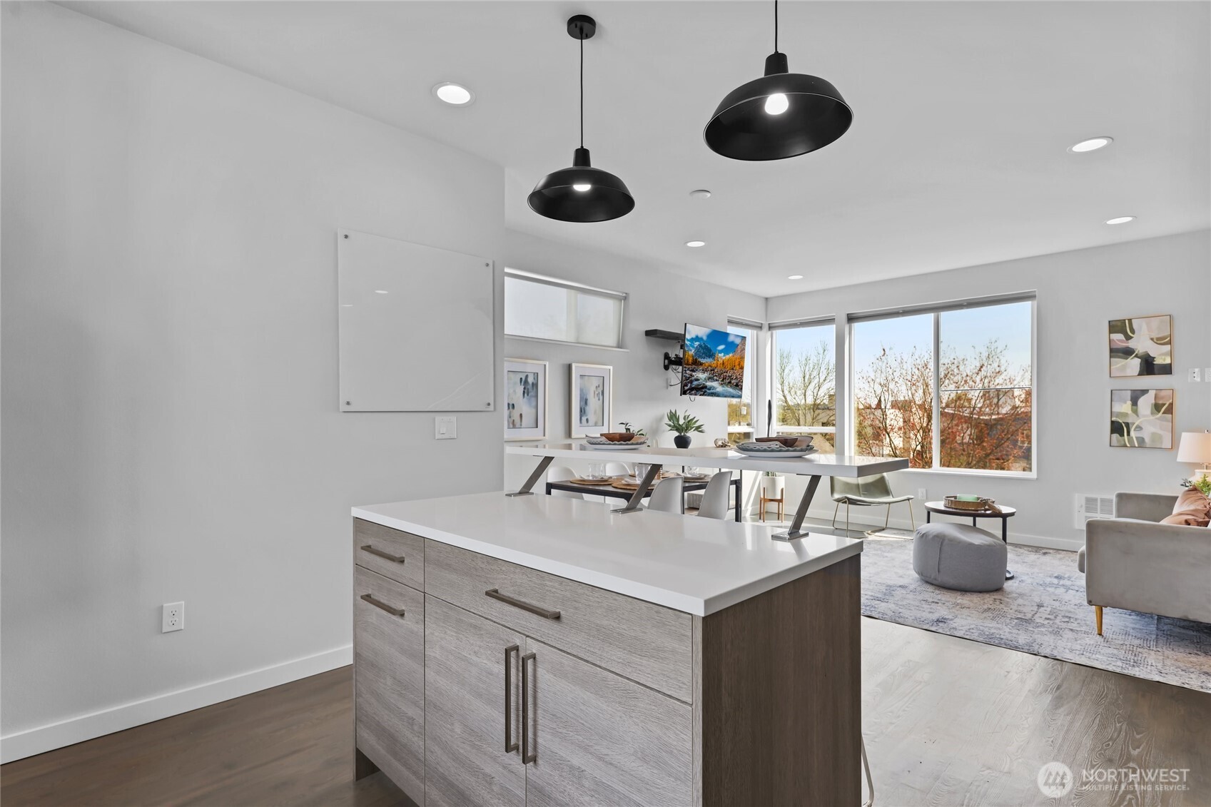 2653 Northwest 64th Street, Unit A Seattle, WA 98107 - Photo 11 of 32 a kitchen with stainless steel appliances granite countertop a sink and chairs