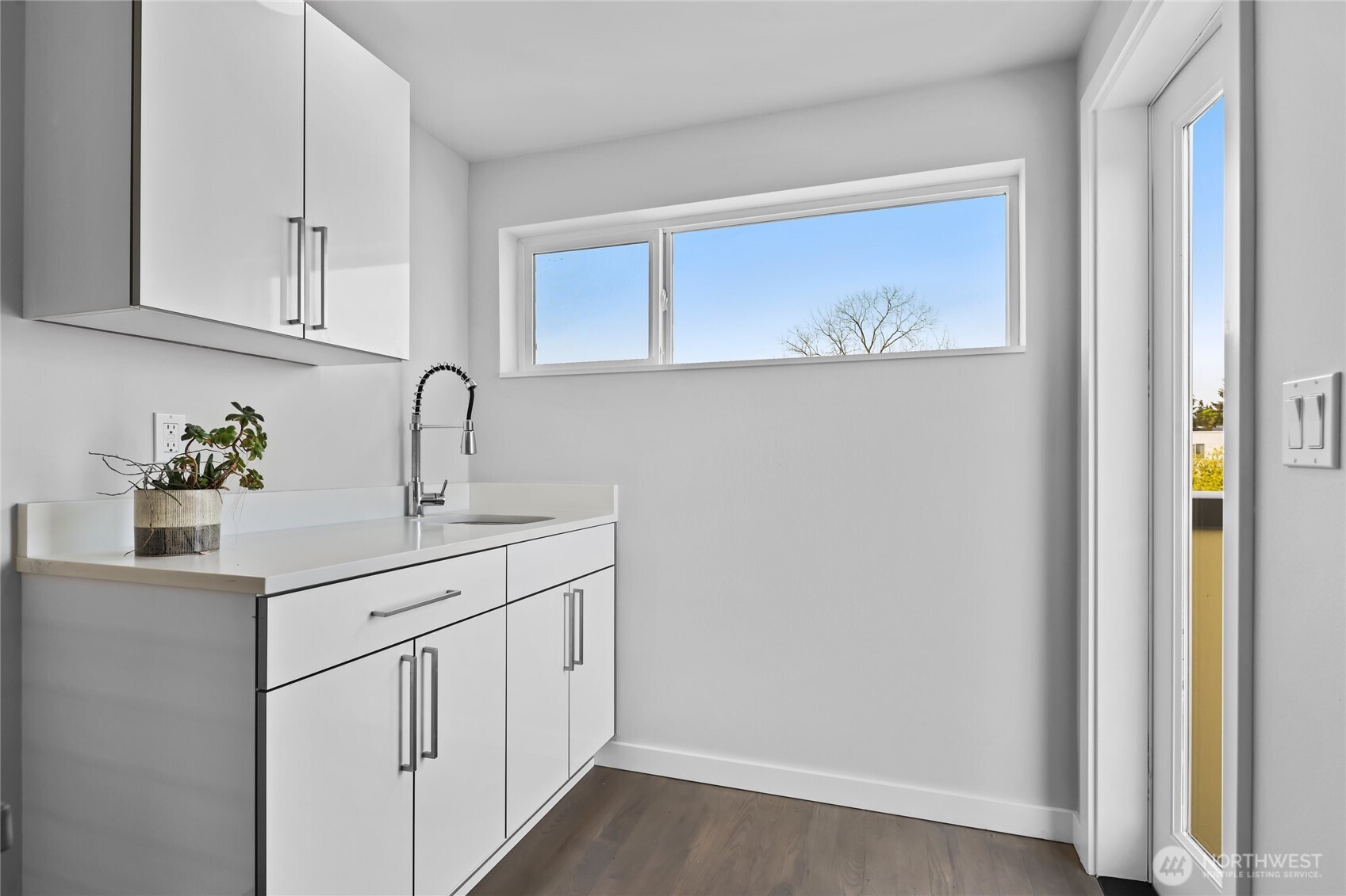 2653 Northwest 64th Street, Unit A Seattle, WA 98107 - Photo 13 of 32 a kitchen with white cabinets and sink