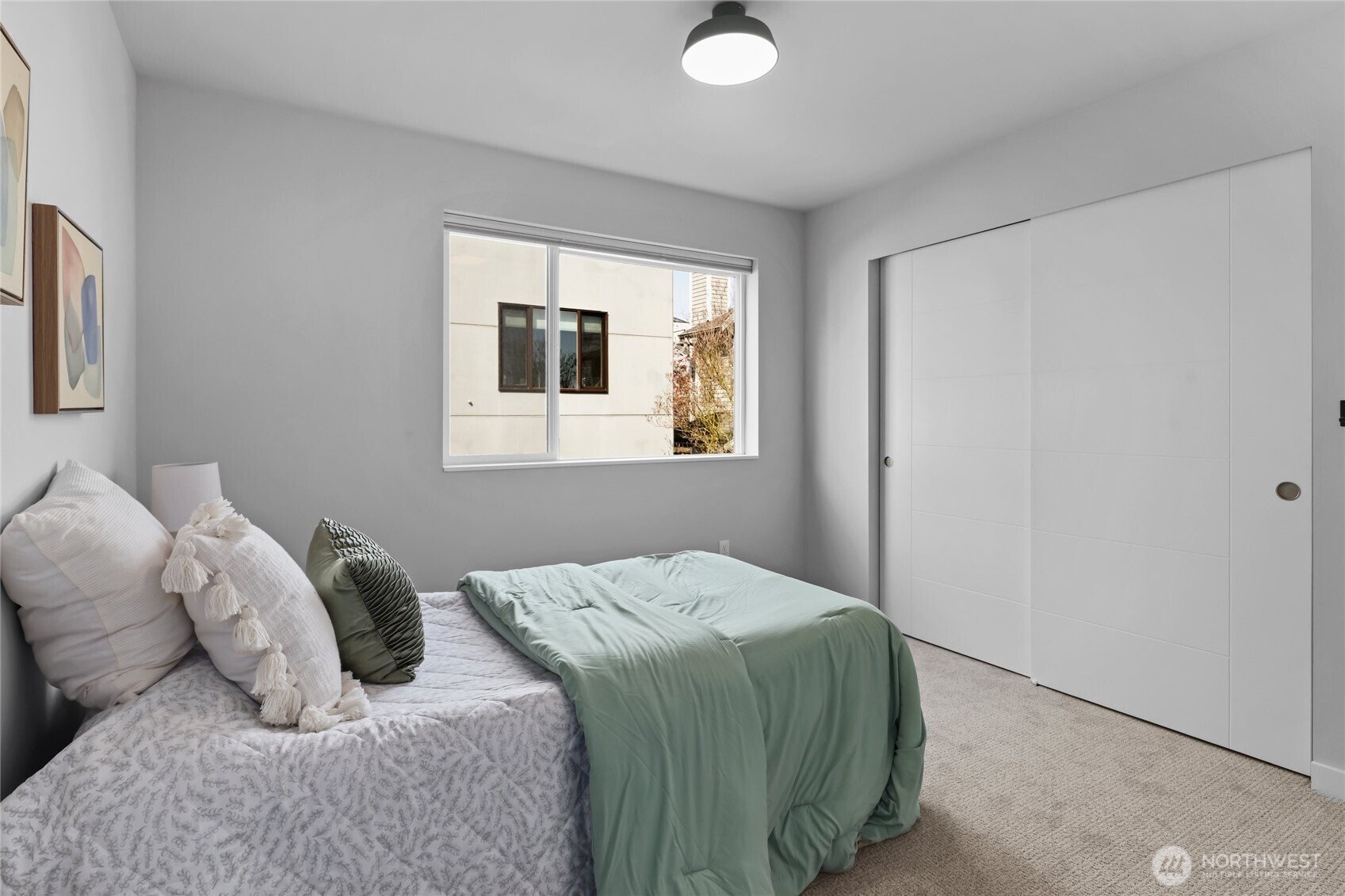 2653 Northwest 64th Street, Unit A Seattle, WA 98107 - Photo 17 of 32 a bedroom with a bed and a window