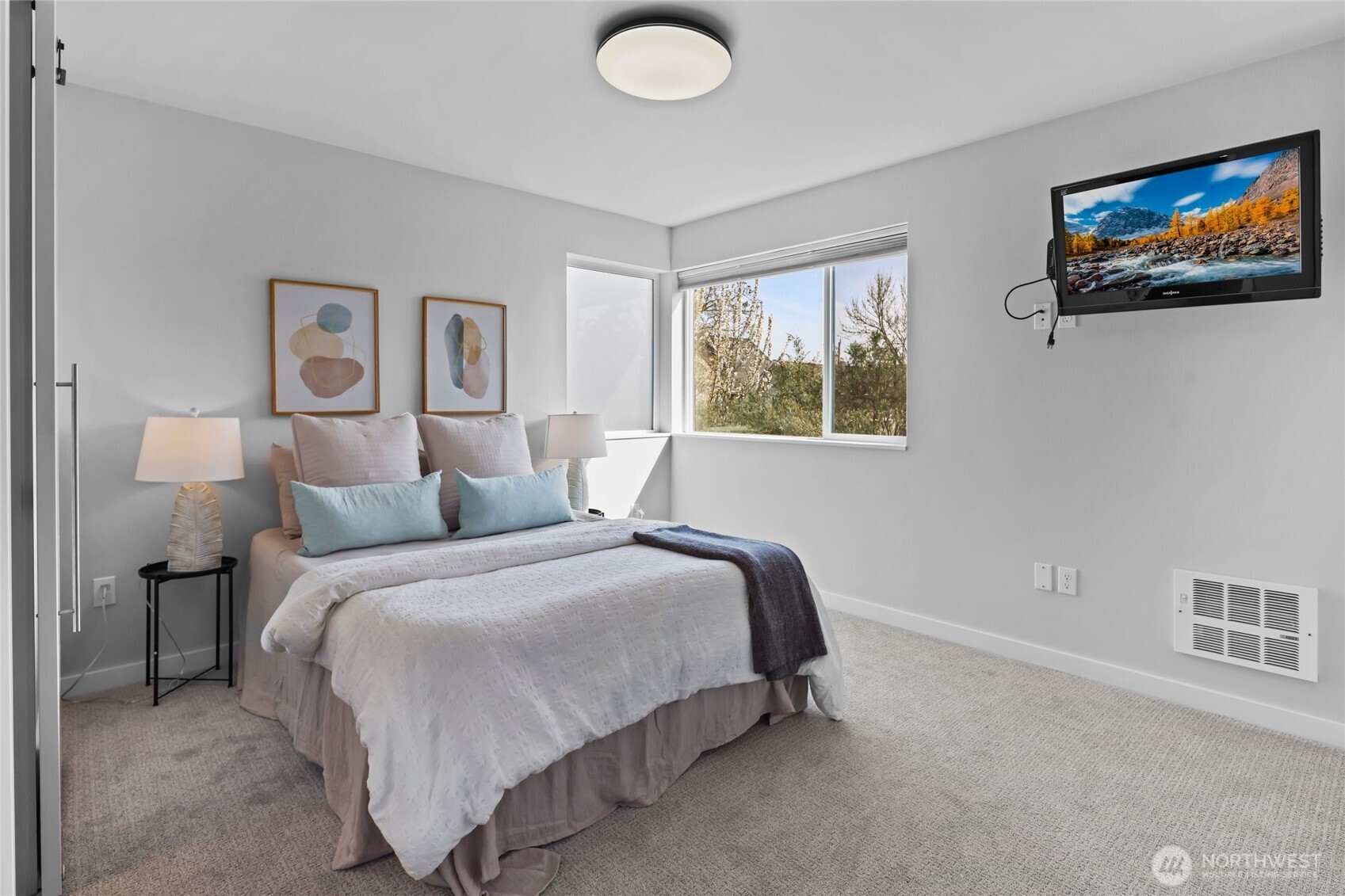 2653 Northwest 64th Street, Unit A Seattle, WA 98107 - Photo 18 of 32 a bedroom with a bed and a painting on the wall