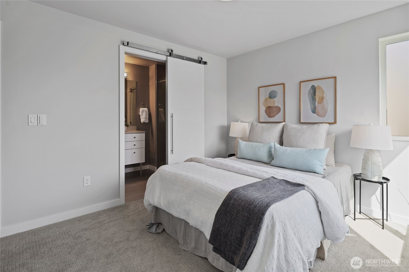 2653 Northwest 64th Street, Unit A Seattle, WA 98107 - Photo 19 of 32 a bedroom with a bed and lamp