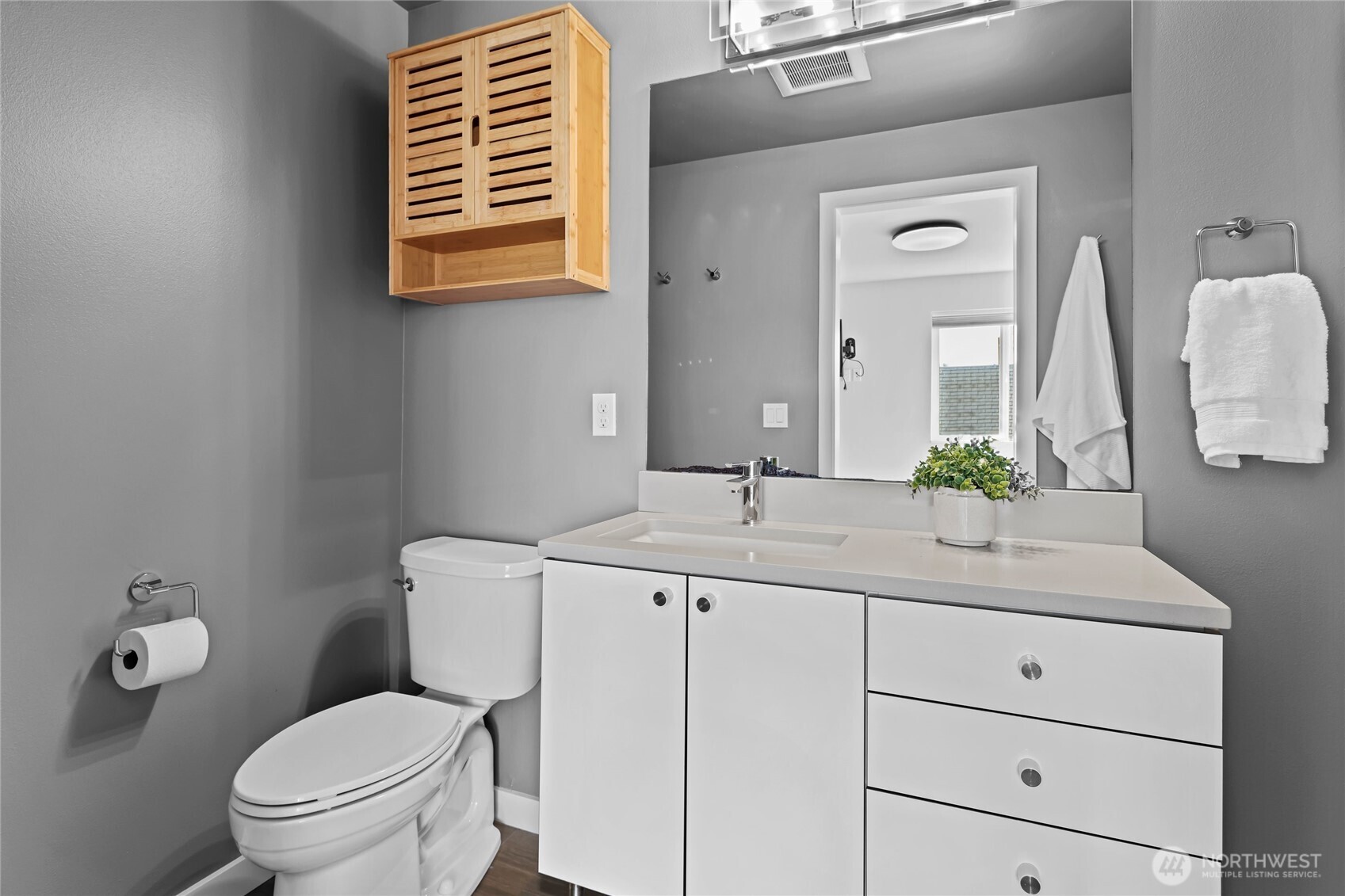 2653 Northwest 64th Street, Unit A Seattle, WA 98107 - Photo 20 of 32 a bathroom with a toilet sink and mirror