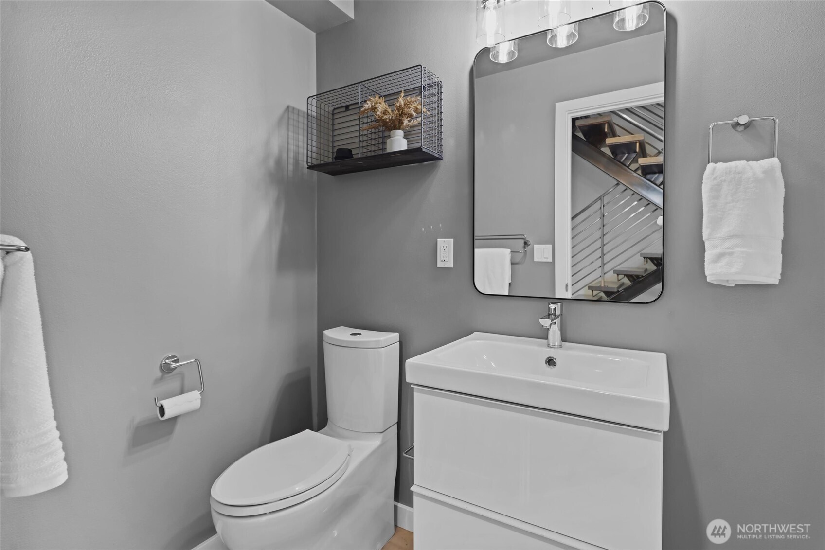 2653 Northwest 64th Street, Unit A Seattle, WA 98107 - Photo 24 of 32 a bathroom with a toilet sink and mirror