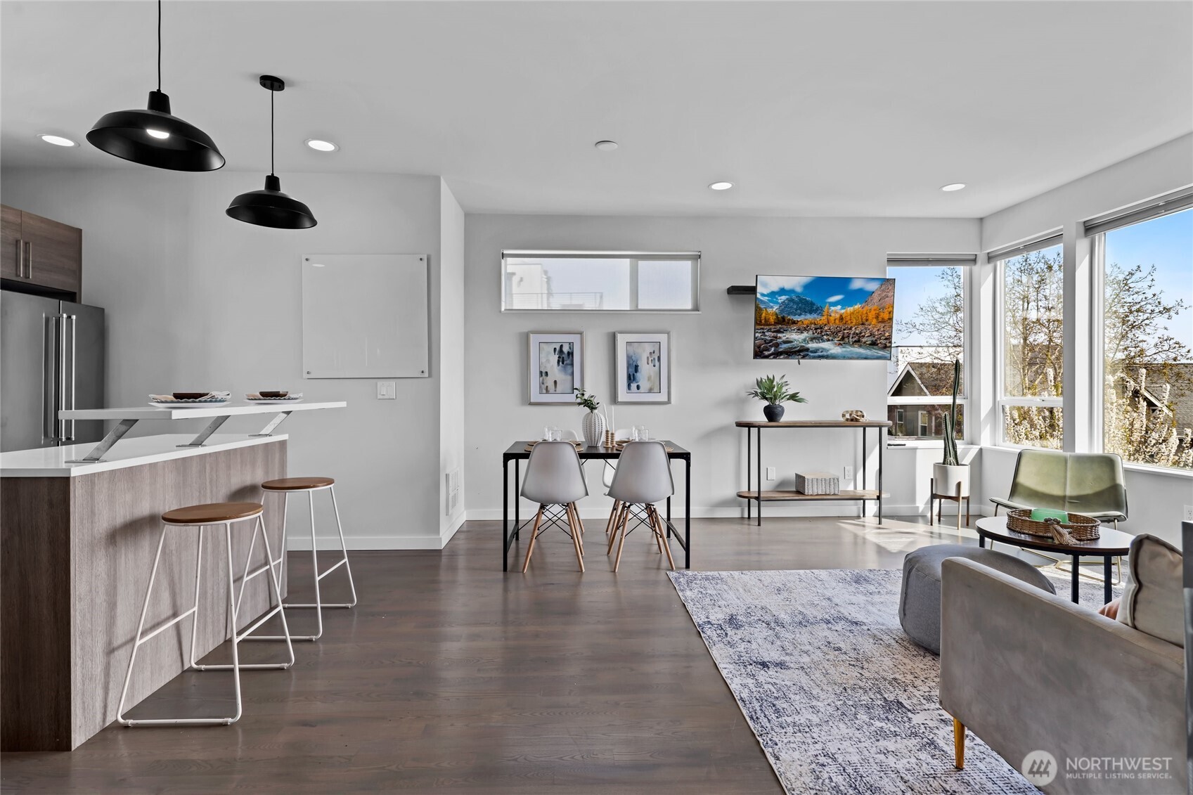 2653 Northwest 64th Street, Unit A Seattle, WA 98107 - Photo 3 of 32 a living room with furniture a dining table and a floor to ceiling window
