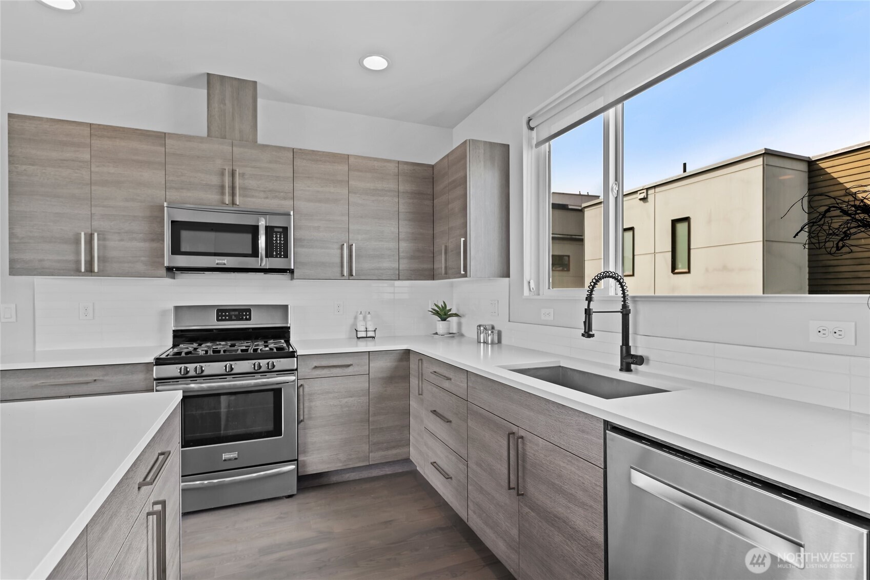 2653 Northwest 64th Street, Unit A Seattle, WA 98107 - Photo 8 of 32 a kitchen with cabinets stainless steel appliances and a sink