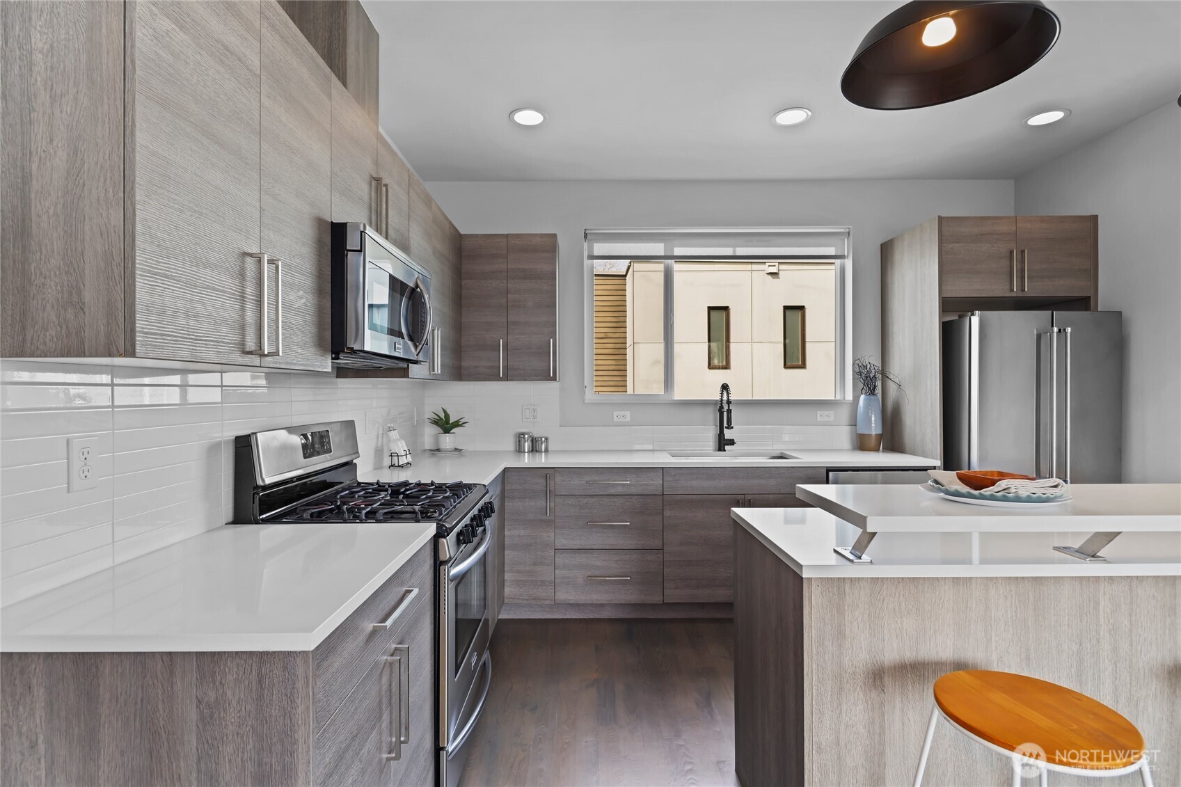 2653 Northwest 64th Street, Unit A Seattle, WA 98107 - Photo 9 of 32 a kitchen that has a sink and a stove in it