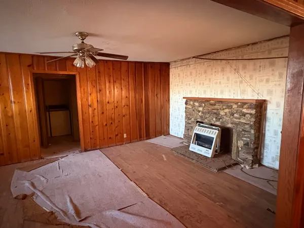 a view of empty room with a fireplace