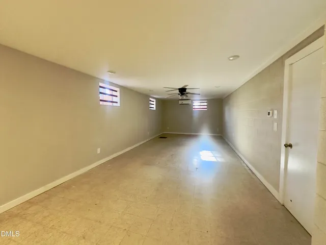 a view of room and hall with wooden floor