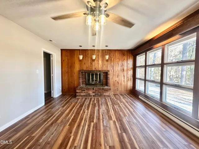 wooden floor in an empty room with a fireplace